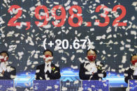 Yoon Suk Yeol, center right, the presidential election candidate of South Korea's main opposition People Power Party (PPP), and Lee Jae-myung, center left, the presidential election candidate of the ruling Democratic Party, attend a ceremony for the first trading day of stock market at the Korea Exchange (KRX) in Seoul, South Korea Monday, Jan. 3, 2022. (Kim Hong-ji/Pool Photo via AP)