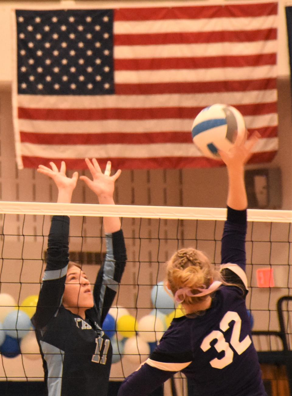 Trinity Pedersen (left) goes up for a block for Central Valley Academy against Little Falls Mountie Avery McLaughlin during the final game of Wednesday's match.