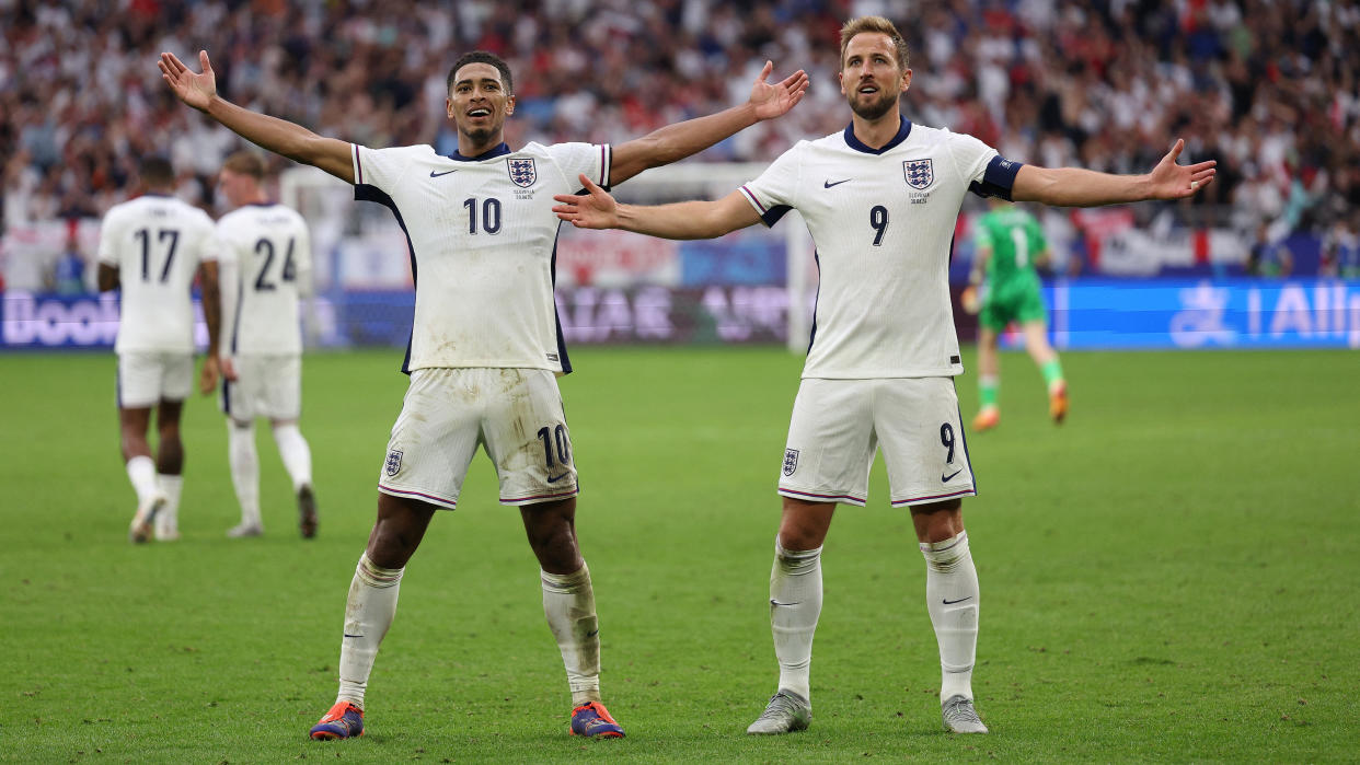 TOPSHOT - England's midfielder #10 Jude Bellingham celebrates with England's forward #09 Harry Kane after scoring his team's first goal during the UEFA Euro 2024 round of 16 football match between England and Slovakia at the Arena AufSchalke in Gelsenkirchen on June 30, 2024. (Photo by Adrian DENNIS / AFP) (Photo by ADRIAN DENNIS/AFP via Getty Images)