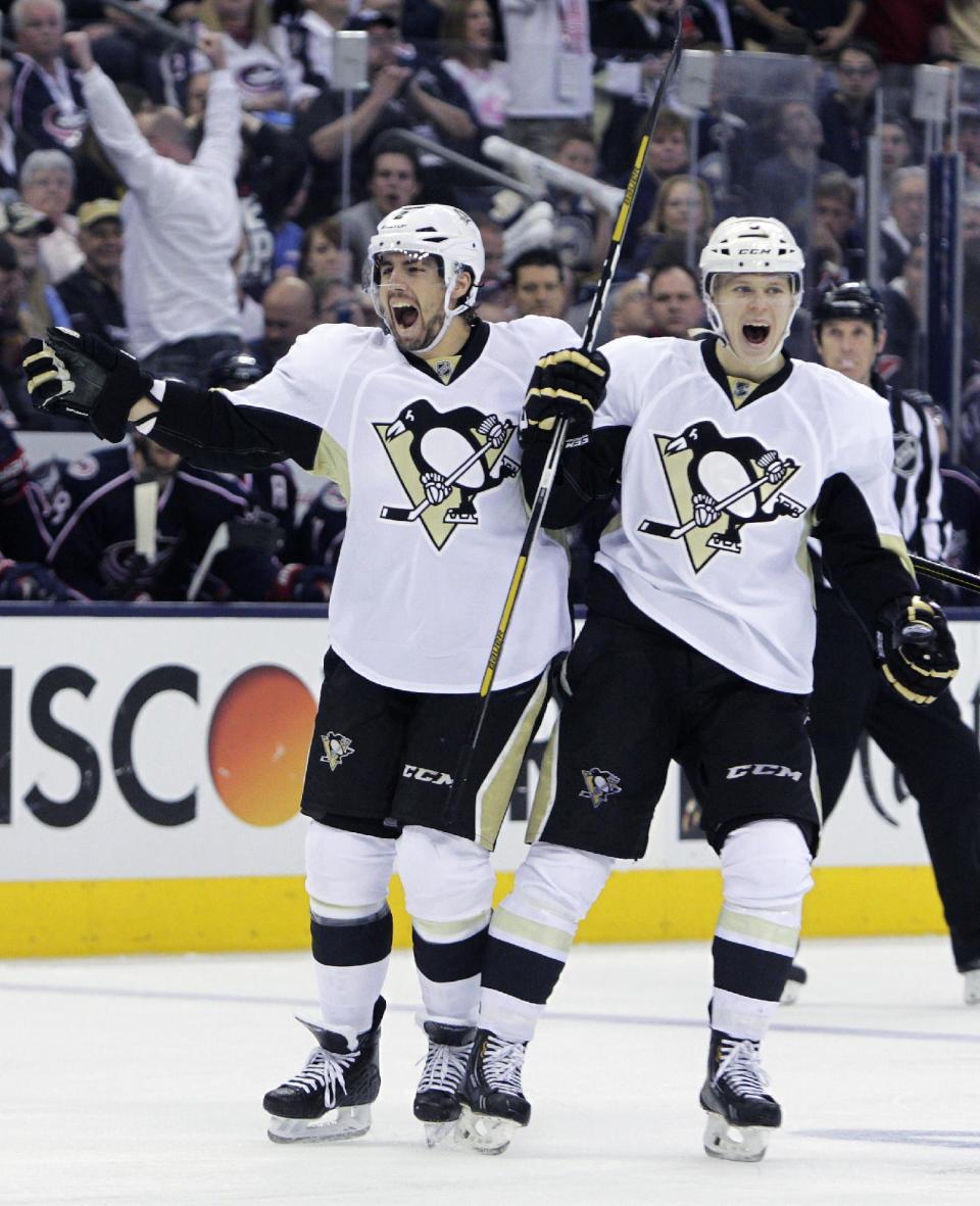 Pittsburgh Penguins' Matt Niskanen, left, and Olli Maatta, of Finland, celebrates Maatta's goal against the Columbus Blue Jackets' during the third period of a first-round NHL playoff hockey game Monday, April 21, 2014, in Columbus, Ohio. The Penguins defeated the Blue Jackets 4-3. (AP Photo/Jay LaPrete)