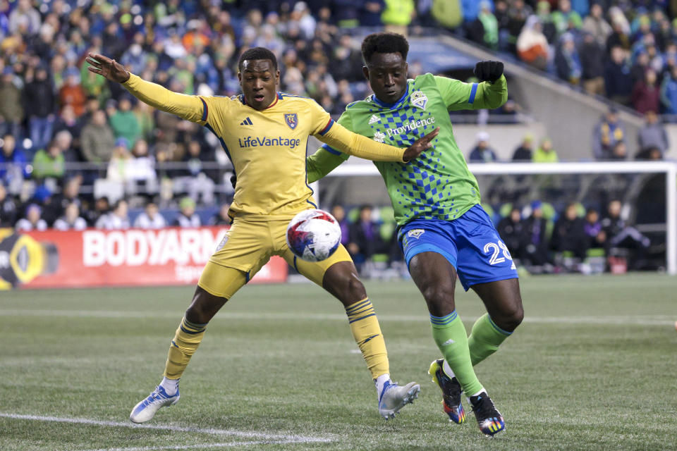 Real Salt Lake midfielder Anderson Julio, left, and Seattle Sounders defender Yeimar Gomez compete for the ball during the first half of an MLS soccer match Saturday, March 4, 2023, in Seattle. (AP Photo/Jason Redmond)