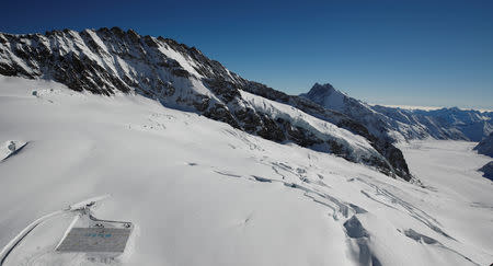 A general view shows 100,000 postcards (bottom L) with messages against climate change, sent by young people from all over the world and stuck together to break the Guinness World Record of the biggest postcard, on the Jungfraufirn, the upper part of Europe's longest glacier, the Aletschgletscher, near Jungfraujoch, Switzerland November 16, 2018. REUTERS/Arnd Wiegmann