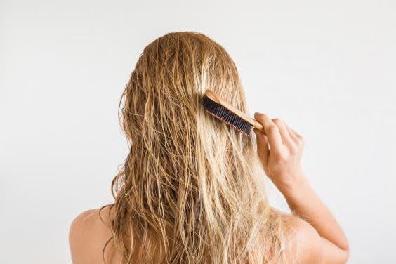 Woman brushing hair (iStock)