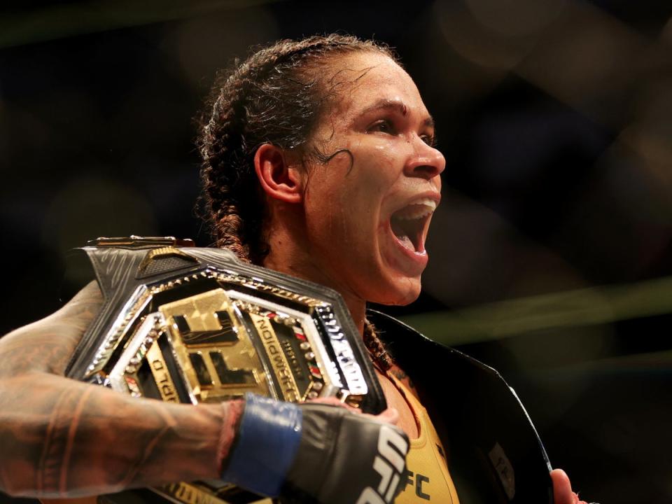 Amanda Nunes with the UFC women’s bantamweight and featherweight titles (Getty Images)