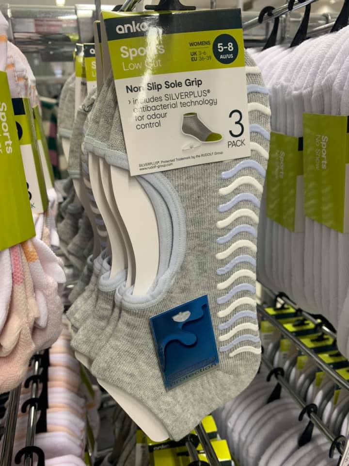 A photo of 'non slip sole grip' socks hanging at Kmart.