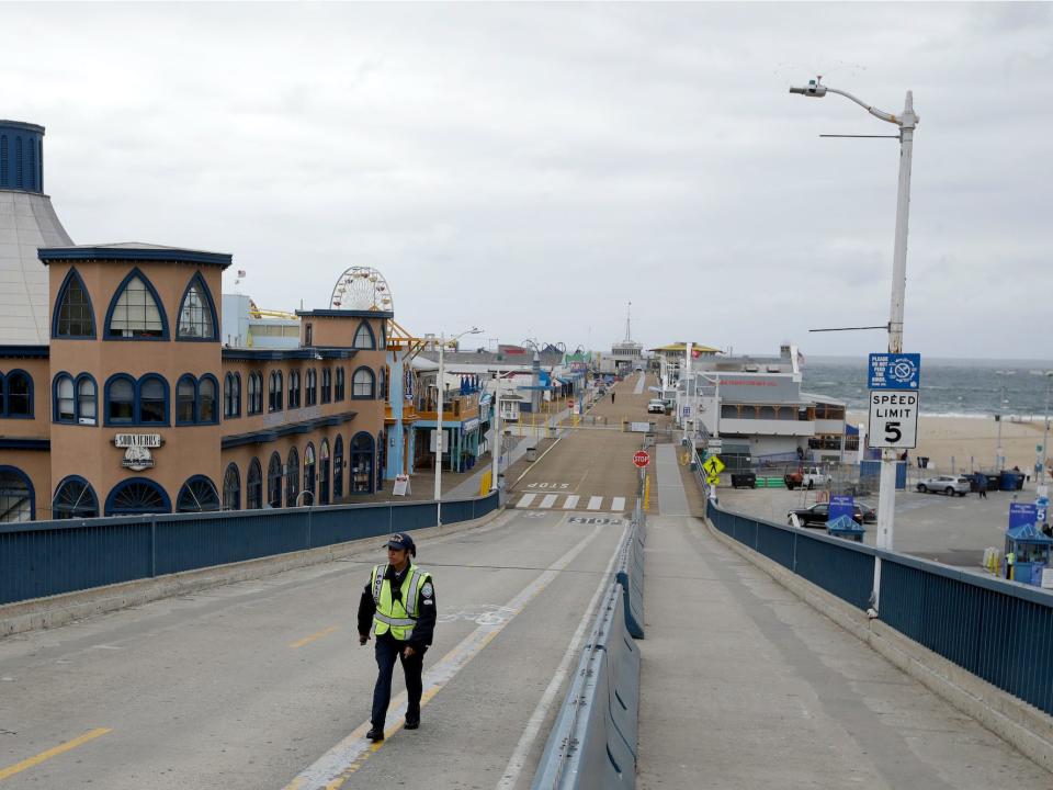 exit road at a near empty Santa Monica Pier following a temporary closure as part of measures to combat the spread of the coronavirus Monday, March 16, 2020