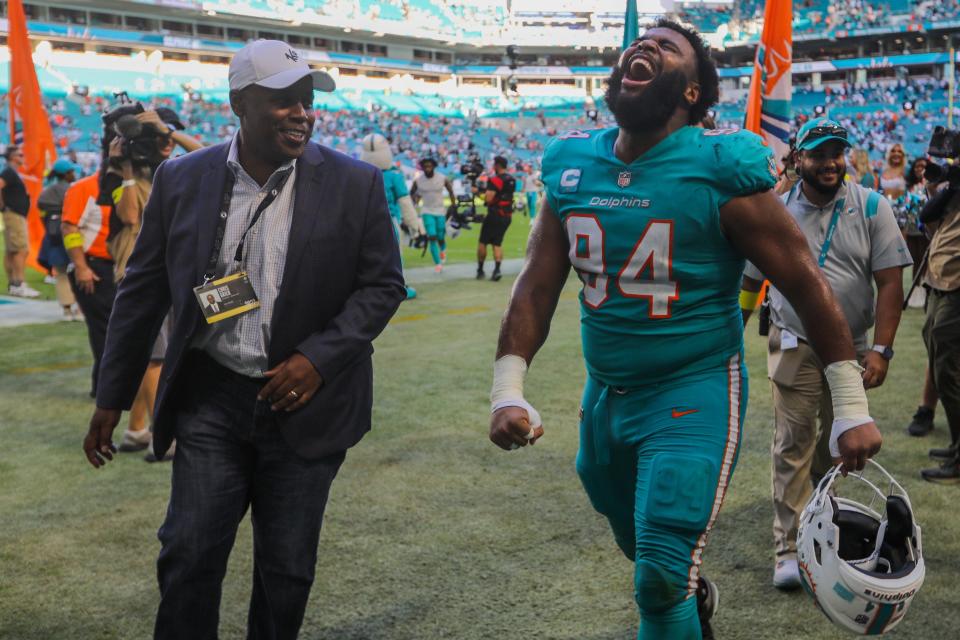 Miami Dolphins General Manager Chris Grier looks on as Miami Dolphins defensive tackle Christian Wilkins (94) celebrates beating the New York Jets at Hard Rock Stadium on Sunday, January 8, 2023, in Miami Gardens, FL.