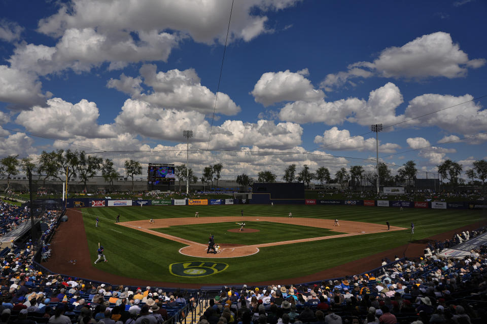 The Texas Rangers and the Milwaukee Brewers compete during the fourth inning of a spring training baseball game, Saturday, March 16, 2024, in Phoenix. (AP Photo/Matt York)