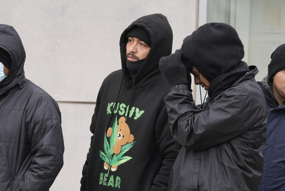 Michael Chavez, 27, of Costa Rica, center, stands in line with other migrants to receive food from the nonprofit Chi-Care Thursday, Jan. 11, 2024, in Chicago. In the city of Chicago's latest attempt to provide shelter to incoming migrants, several CTA buses were parked in the area of 800 South Desplaines Street to house people in cold winter weather. (AP Photo/Erin Hooley)