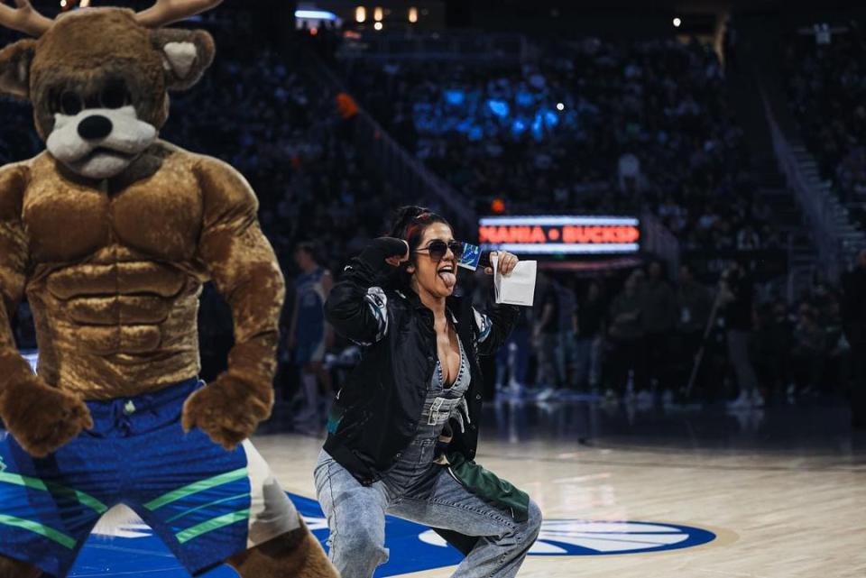 WWE superstar Bayley flexes with Bango during the Milwaukee Bucks game against the Brooklyn Nets on Thursday, March 21, 2024. She was in attendance to promote "SmackDown" on Friday at Fiserv Forum.