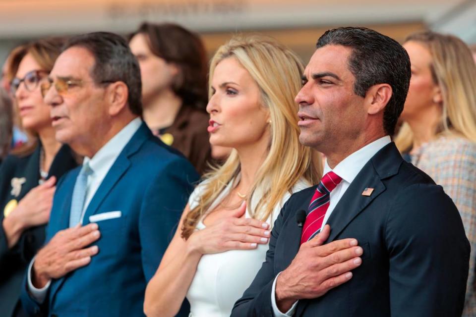 Miami Mayor Francis Suarez (right); his wife, Gloria; and his father, former City of Miami Mayor Xavier Suarez (left), listen to the national anthem before his first speech as a candidate for the 2024 Republican presidential nomination at the Ronald Reagan Presidential Library in Simi Valley, California, on Thursday, June 15, 2023.