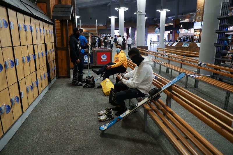 People wearing protective face masks prepare to ski at Ski Dubai during the reopening of malls, following the outbreak of the coronavirus disease (COVID-19), at Mall of the Emirates in Dubai
