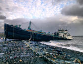 A 168-foot water tanker, the John B. Caddell, sits on the shore Tuesday morning, Oct. 30, 2012 where it ran aground on Front Street in the Stapleton neighborhood of New York's Staten Island as a result of superstorm Sandy. (AP Photo/Sean Sweeney)