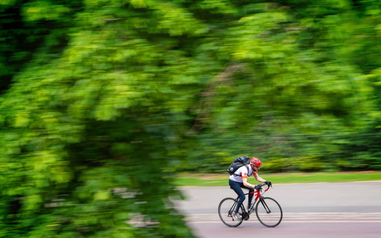 A cyclist rides in the sunshine in Greenwich Park - Dominic Lipinski/PA 