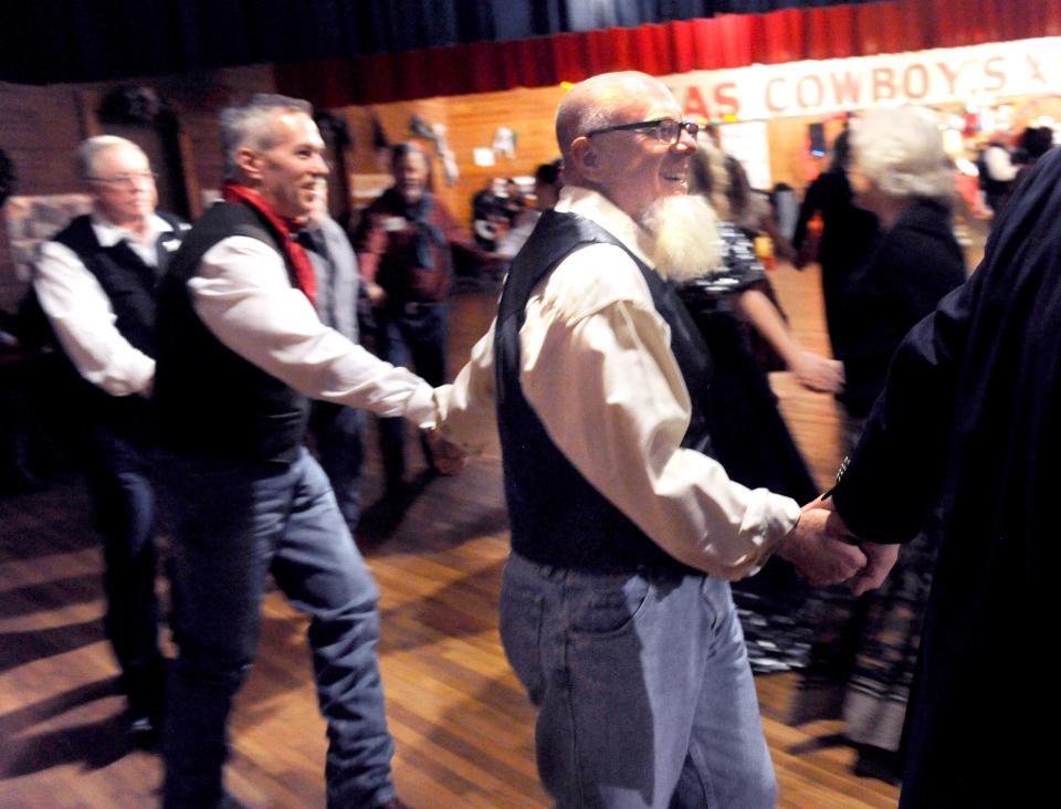 Reporter-News columnist Greg Jaklewicz spins through the line during the Paul Jones dance at the Texas Cowboys' Christmas Ball in Anson on Dec. 17, 2015.