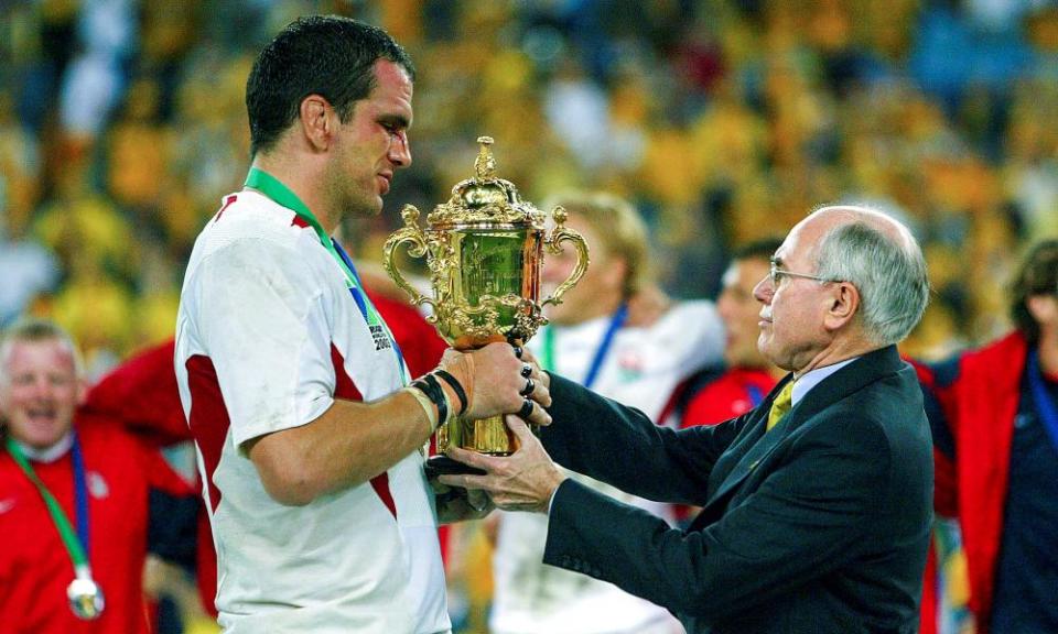 Then-PM John Howard presenting the Web Ellis Cup to English captain Martin Johnson after the 2003 Rugby World Cup final in Sydney.