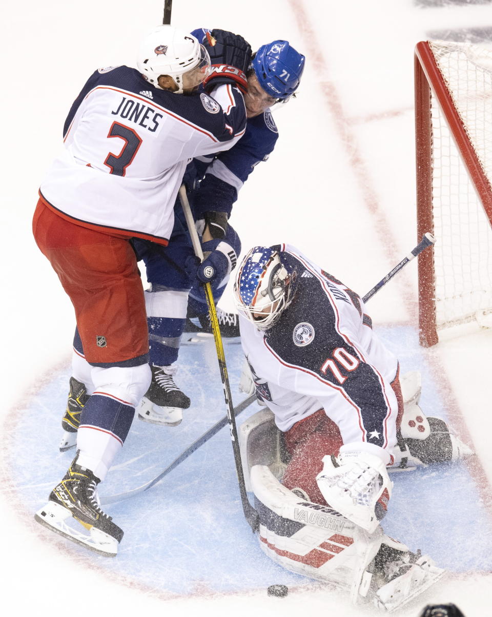 Columbus Blue Jackets defenceman Seth Jones (3) picks up a holding call as Tampa Bay Lightning center Anthony Cirelli (71) makes a short-handed breakaway attempt on Jackets goaltender Joonas Korpisalo (70) during the second period of an NHL Eastern Conference Stanley Cup first-round playoff hockey game in Toronto on Tuesday, August 11, 2020. (Frank Gunn/The Canadian Press via AP)