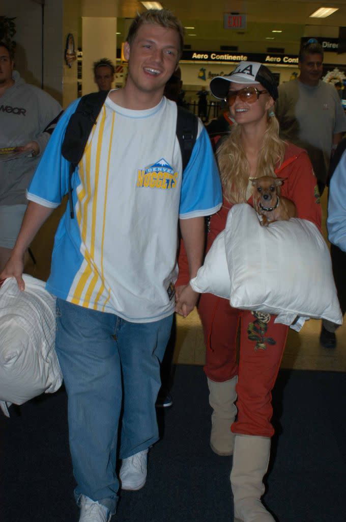 Nick Carter and Paris Hilton at the Miami airport, 2004. Ugg were a staple of the heiress’s uniform during the early aughts. - Credit: Splash