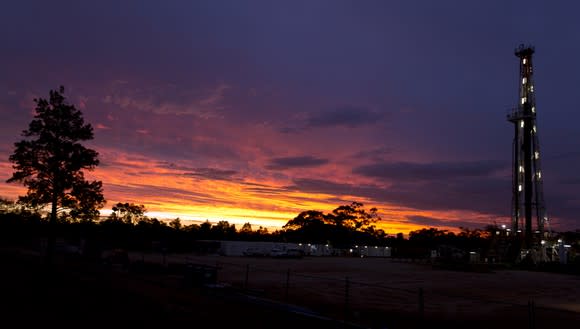 A land rig drilling at sunset.