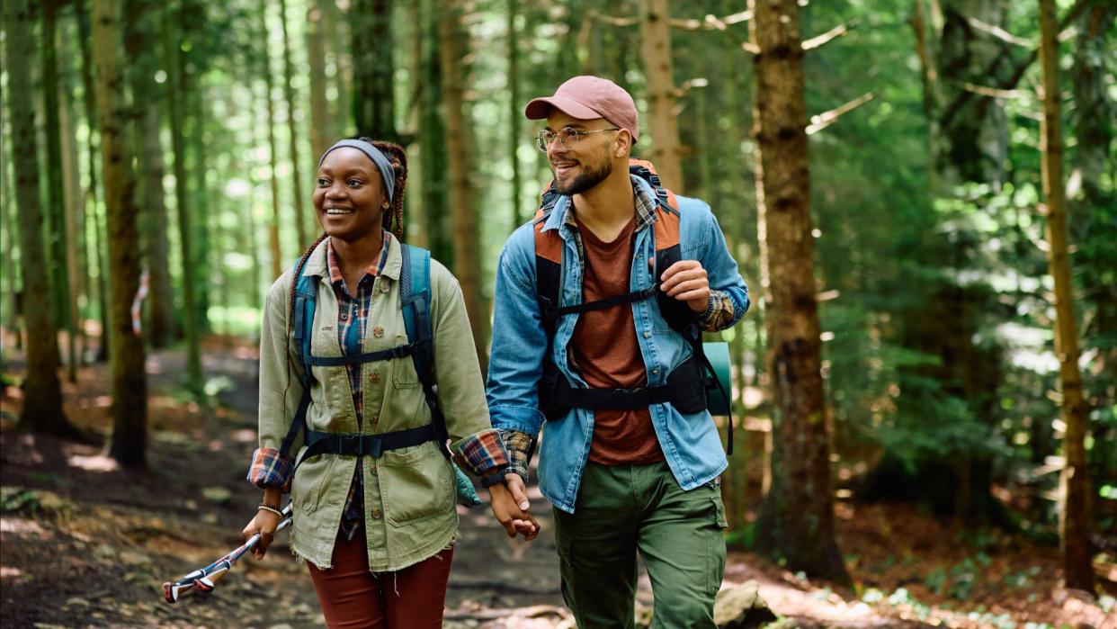  A couple hiking through the woods. 