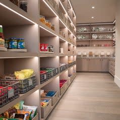 Tall wood built in shelves filled with matching baskets filled with colorful food items