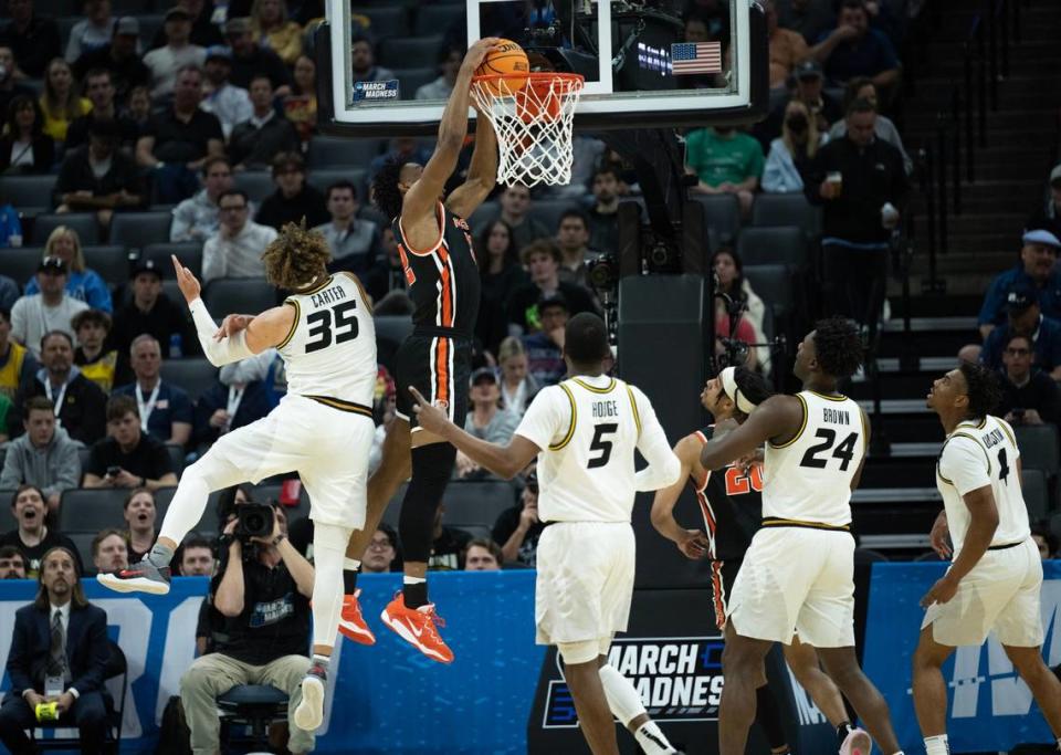 Princeton Tigers forward Keeshawn Kellman (32) dunks the ball defended by Missouri Tigers forward Noah Carter (35) during a game in the NCAA Tournament at Golden 1 Center in Sacramento, Saturday, March 18, 2023.