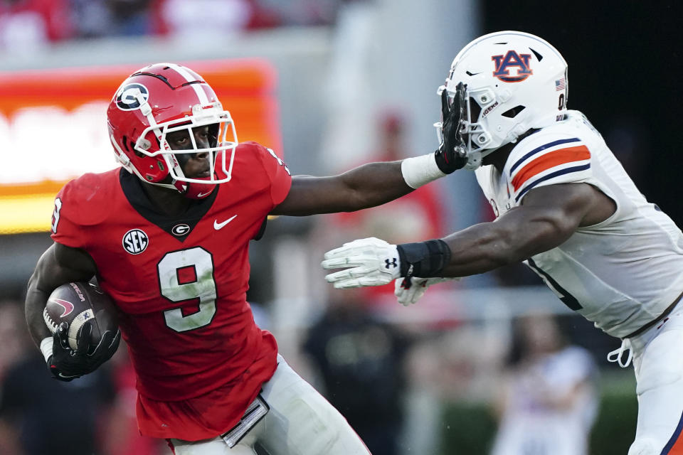 Georgia wide receiver Jackson Meeks (9) tries to fight off Auburn linebacker Owen Pappoe (0) after a catch during the second half of an NCAA college football game Saturday, Oct. 8, 2022, in Athens, Ga. (AP Photo/John Bazemore)