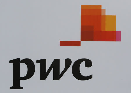 FILE PHOTO: The logo of accounting firm PricewaterhouseCoopers (PwC) is seen on a board at the St. Petersburg International Economic Forum 2017 (SPIEF 2017) in St. Petersburg, Russia, June 1, 2017. EUTERS/Sergei Karpukhin/File Photo