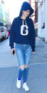 <p>Gigi went incognito on the streets of New York—well, almost: that “G”-bearing Good American sweatshirt ($160; <a rel="nofollow noopener" href="http://www.pntra.com/t/8-11323-131940-149447?ISGigiIJJanurl=https%3A%2F%2Fwww.goodamerican.com%2Fproducts%2Fgood-hoodie-g-navy" target="_blank" data-ylk="slk:goodamerican.com;elm:context_link;itc:0;sec:content-canvas" class="link ">goodamerican.com</a>) kind of gave the model away. Hadid paired her top with a set of straight-leg ripped jeans, white sneaks, bold blue socks, a navy baseball cap, and round-lens glasses.</p>