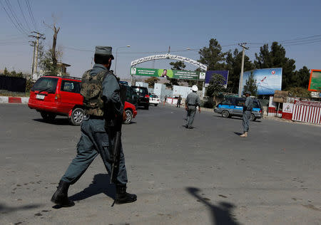 Afghan policemen stand guard outside of Kabul Airport after rockets exploded in Kabul, Afghanistan September 27, 2017. REUTERS/Mohammad Ismail