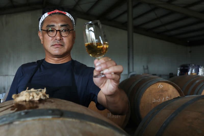 Chen Chien-hao, 52, holds a glass of his wine at Shu Sheng Leisure Domaine in Taichung