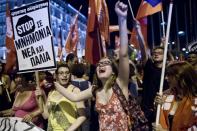 People shout slogans in front of parliament in Athens on July 5, 2015 after the first exit-polls of the Greek referendum