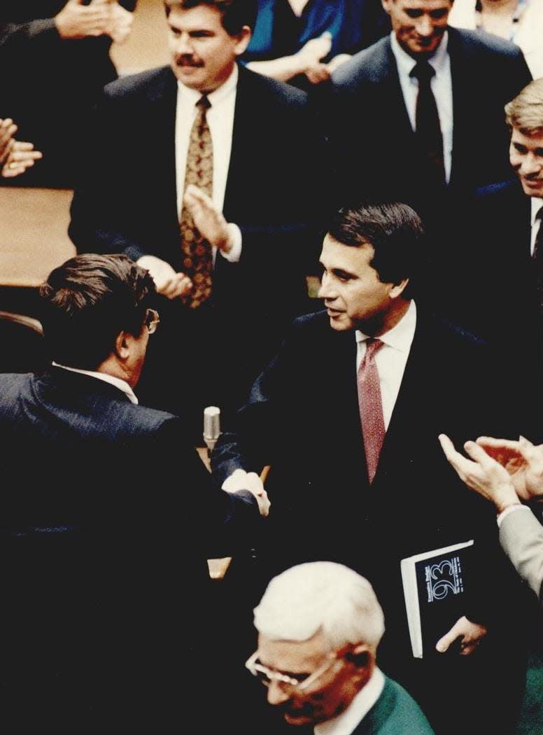 Budget proposals in hand, Gov. David Walters greets legislators Monday before delivering his State of the State Address in 1992.