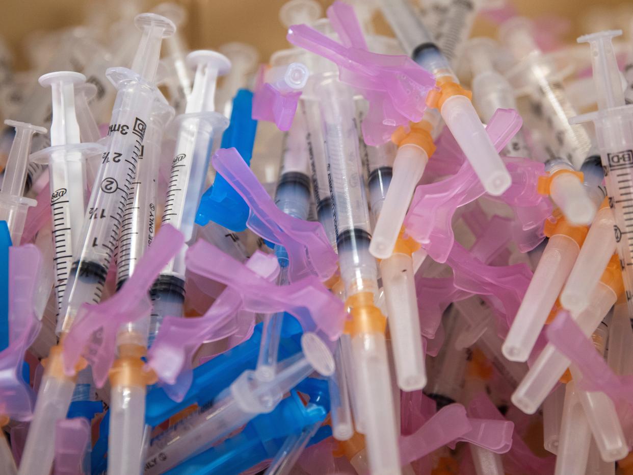 <p>Syringes filled with the Moderna vaccine await patients at a vaccination super station in California</p> (REUTERS)