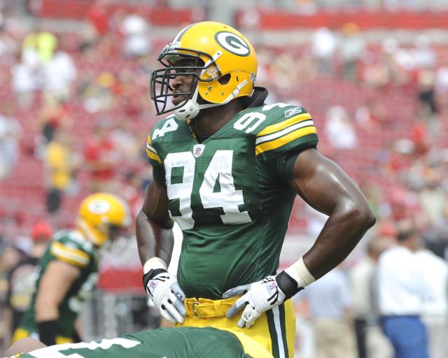 Green Bay Packers defensive end Kabeer Gbaja-Biamila wipes sweat away  during an Organized Team Activity (OTA) football session, Wednesday, May  31, 2006, in Green Bay, Wis. The Packers will continue to run