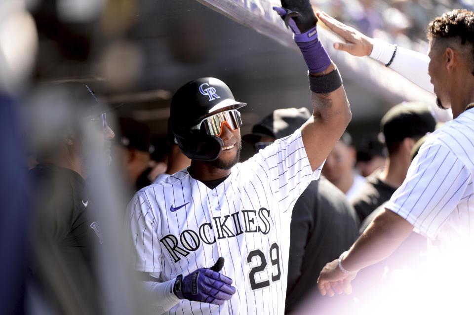 Colorado Rockies' Jurickson Profar and Ezequiel Tovar celebrate Profar's home run in the fifth inning of a baseball game, Sunday, April 9, 2023, in Denver. (AP Photo/Geneva Heffernan)