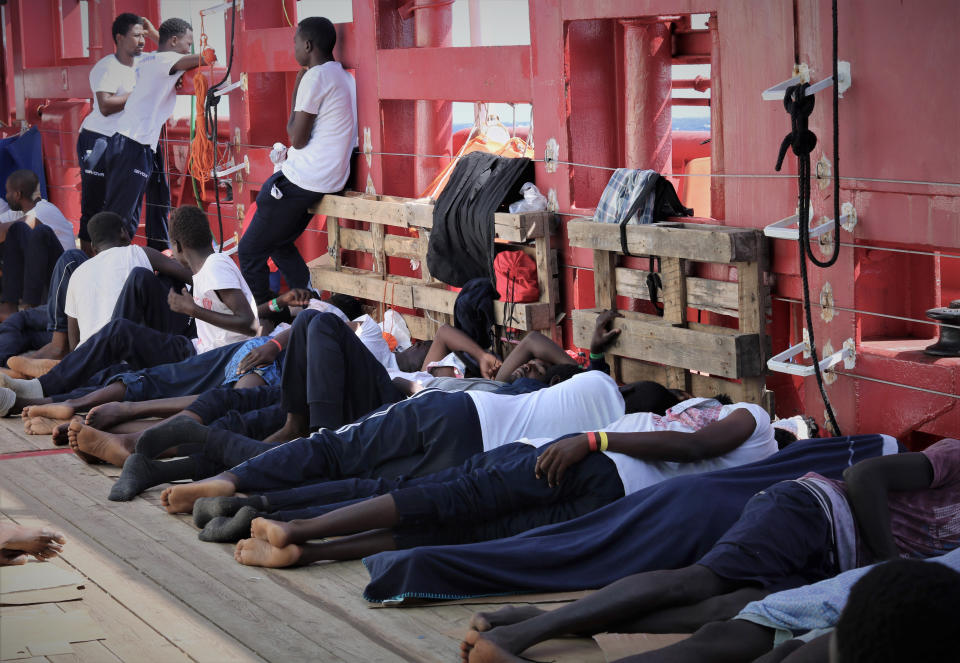 In this Aug. 13, 2019 photo made available Monday, Aug. 19, 2019, rescued migrants rest on the deck of the Norwegian-flagged Ocean Viking vessel, operated by two French humanitarian groups, as it sails in the waters between the Italian island of Linosa, southern Italy, and Malta. Another potential migrant standoff looms as the Ocean Viking, carrying 356 migrants, has been sailing for 10 days without being able to dock after Malta refused to find a safe port while Italy hasn't answered the ship's request. (Hannah Wallace Bowman/MSF via AP)