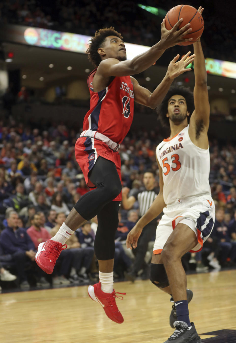 Stony Brook guard Tavin Pierre Philippe (15) shoots next to Virginia guard Tomas Woldetensae (53) during an NCAA college basketball game in Charlottesville, Va., Wednesday, Dec. 18, 2019. (AP Photo/Andrew Shurtleff)