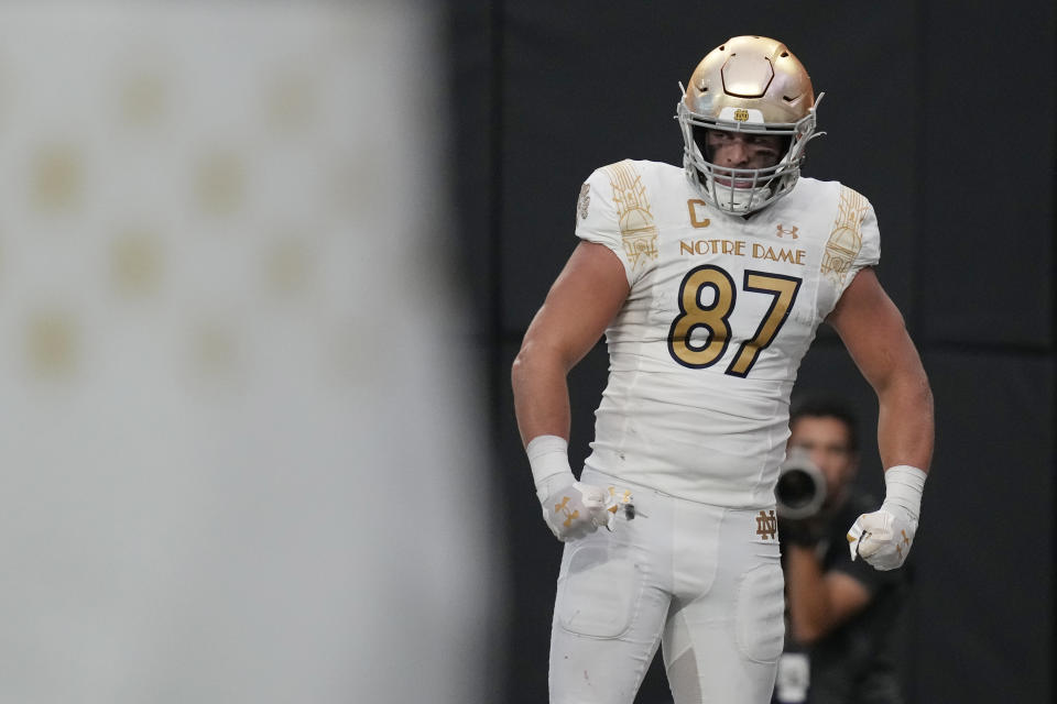 FILE - Notre Dame tight end Michael Mayer (87) celebrates after scoring a touchdown against BYU during the first half of an NCAA college football game Saturday, Oct. 8, 2022, in Las Vegas. Mayer was selected to The Associated Press All-America team released Monday, Dec. 12, 2022. (AP Photo/John Locher, File)