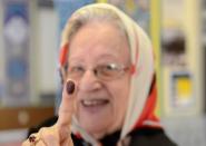 An Iranian citizen shows her finger covered in ink after voting in the Iranian presidential election at a polling station set up inside the Manassas Masjid mosque in Manassas, Virginia, in the United States on June 14, 2013. Moderate cleric Hassan Rowhani, bolstered by a late surge in support from suppressed Iranian reformists, was leading the race on Saturday