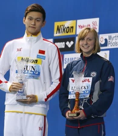 China's Sun Yang and Katie Ledecky of the U.S. (R) pose with their awards for best swimmers of the championships, at the Aquatics World Championships in Kazan, Russia, August 9, 2015. REUTERS/Michael Dalder