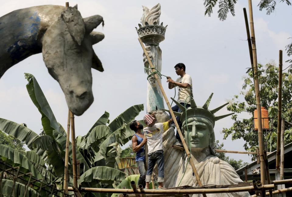 <p>Workers build a large replica of the Statue of Liberty at a workshop in Jakarta, Indonesia. The sculpture will be installed at a public park to attract visitors. (AP Photo/Tatan Syuflana). </p>