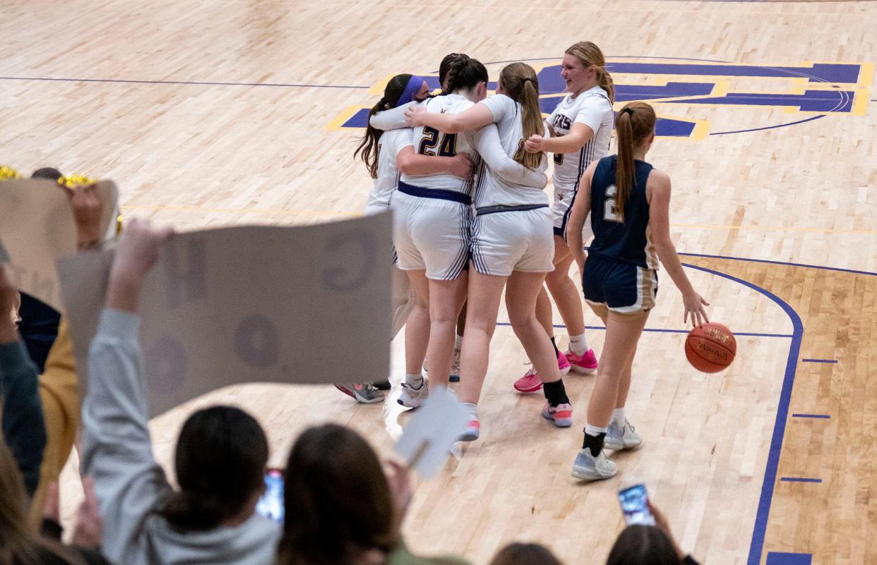 Upper Moreland's Holly Gohl (24) being embraced by her teammates after scoring her 1,000th point against Lower Moreland in a Dec. 5, 2023, game.