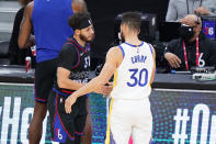 Philadelphia 76ers' Seth Curry, left, and Golden State Warriors' Stephen Curry meet before an NBA basketball game, Monday, April 19, 2021, in Philadelphia. (AP Photo/Matt Slocum)