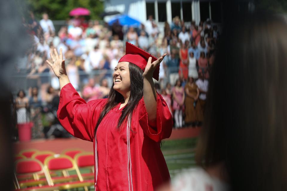 Milford High graduate Olivia Zorzi conducts the concert choir during the graduation ceremony at Milford High School, June 12, 2022.