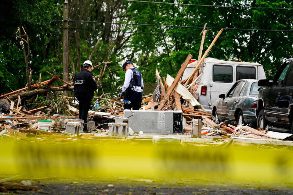 Investigators work the scene of a deadly explosion in a residential neighborhood in Pottstown, Pa., Friday, May 27, 2022. A house exploded northwest of Philadelphia, killing several people and leaving a few others injured, authorities said Friday. (AP Photo/Matt Rourke)