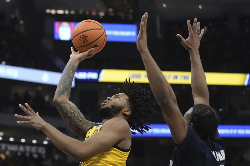 Marquette's David Joplin shoots past Xavier's Quincy Olivari during the first half of an NCAA college basketball game Sunday, Feb. 25, 2024, in Milwaukee. (AP Photo/Morry Gash)