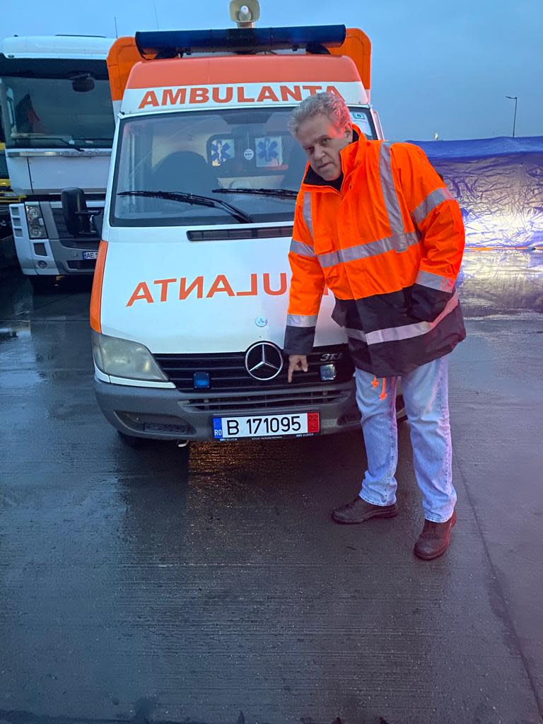 Marco Katz stands with an ambulance on a ferry over the Danube River. Katz, who works in Romania, helped Ody Norkin of Okemos deliver the ambulance to Odessa, Ukraine.