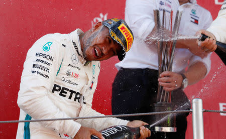 Formula One F1 - Spanish Grand Prix - Circuit de Barcelona-Catalunya, Barcelona, Spain - May 13, 2018 Mercedes’ Lewis Hamilton sprays champagne as he celebrates on the podium after winning the race REUTERS/Juan Medina