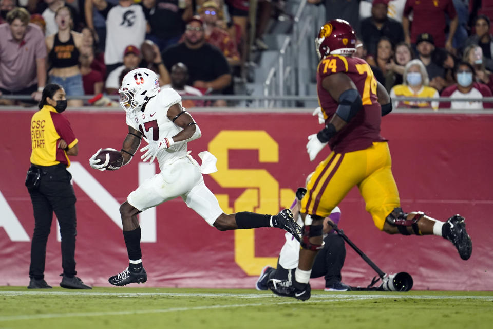 Stanford cornerback Kyu Blu Kelly, left, returns an interception for a touchdown during the second half of the team's NCAA college football game against Southern California on Saturday, Sept. 11, 2021, in Los Angeles. (AP Photo/Marcio Jose Sanchez)